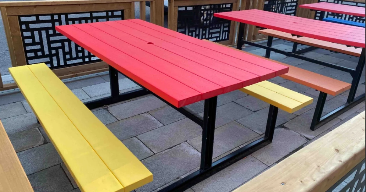 Colorful red and yellow picnic table on a patio